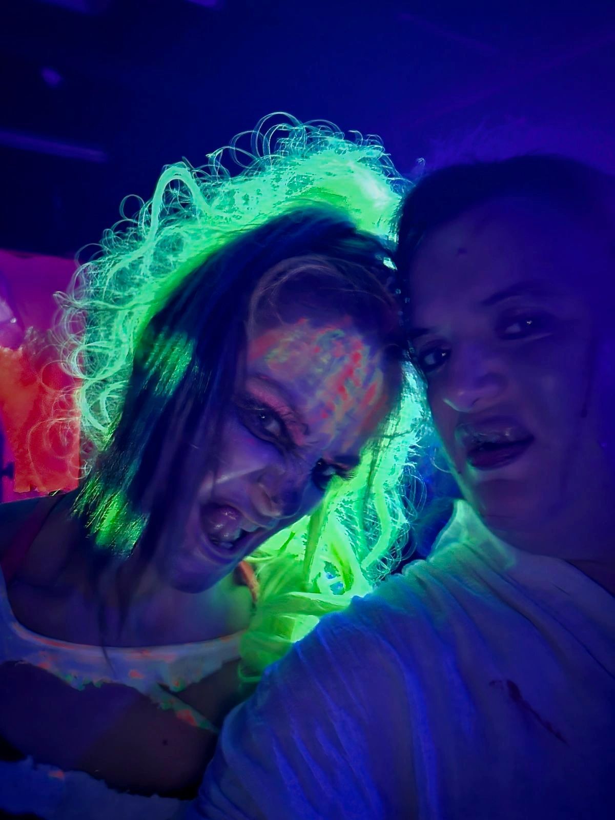 Neon glowing performers at the Haunted Hotel
